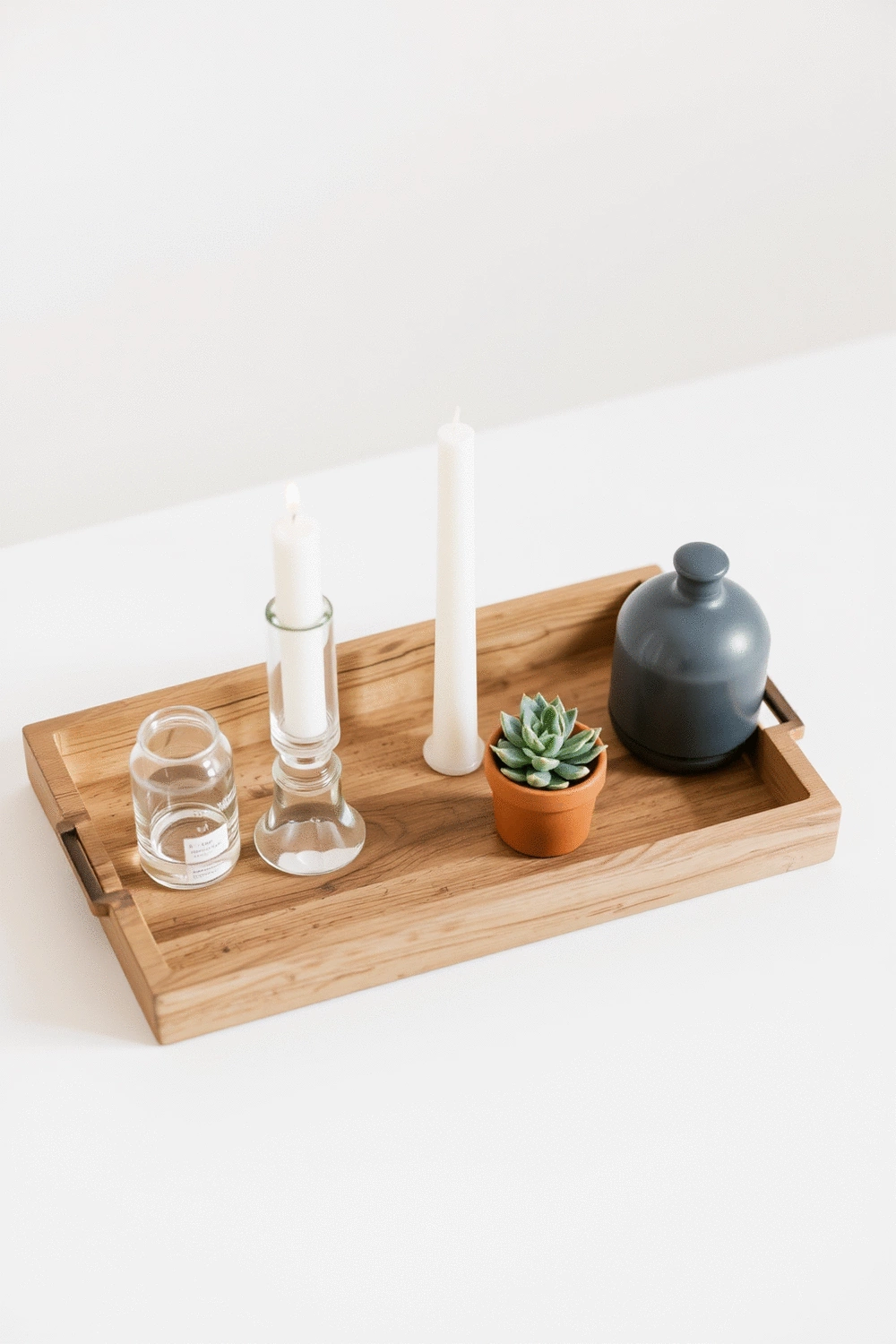 Various affordable accessories for a console table, including a decorative tray, candles, and a small succulent plant